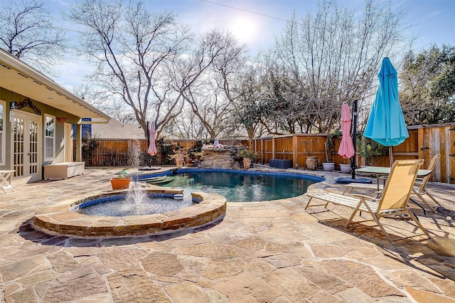 view of swimming pool with a patio area, french doors, and pool water feature