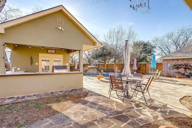 view of patio / terrace with a bar and french doors