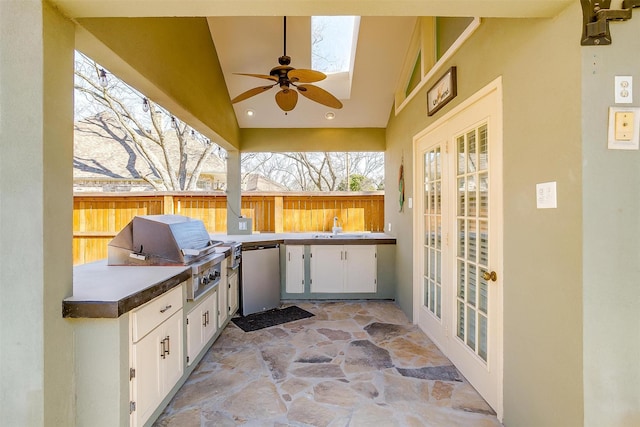 view of patio featuring ceiling fan, a grill, an outdoor kitchen, and french doors