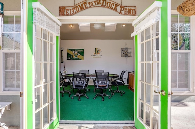 sunroom / solarium featuring french doors