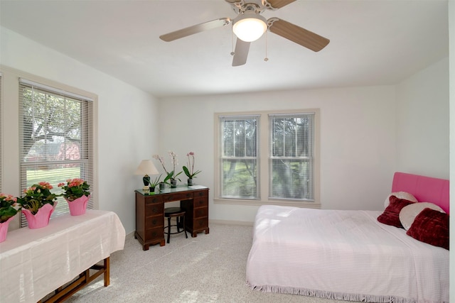 bedroom featuring light carpet and ceiling fan