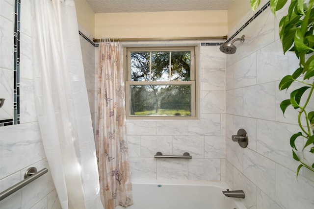 bathroom featuring a textured ceiling and shower / tub combo with curtain