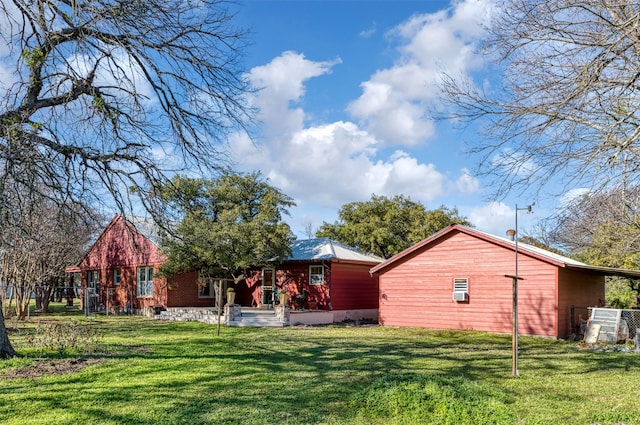 back of house with a lawn