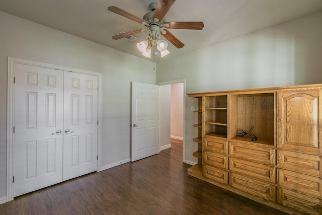 bedroom with ceiling fan, dark hardwood / wood-style flooring, and a closet