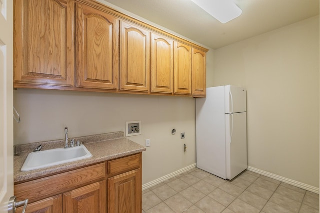 laundry room featuring cabinets, sink, washer hookup, hookup for an electric dryer, and light tile patterned flooring