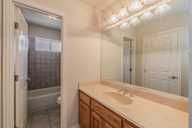 bathroom with toilet, vanity, and tile patterned floors