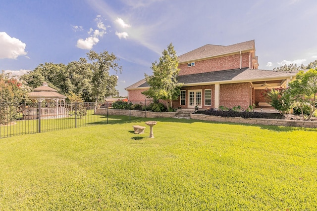 view of yard featuring a gazebo and french doors