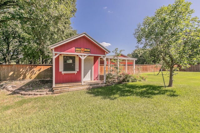 view of outbuilding with a yard