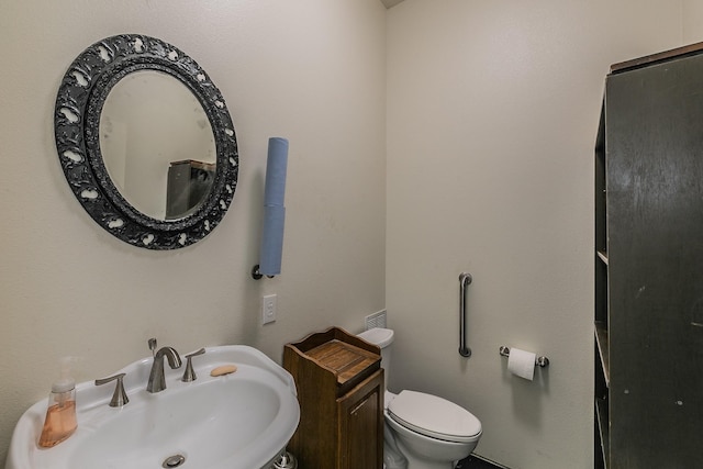 bathroom with toilet and sink