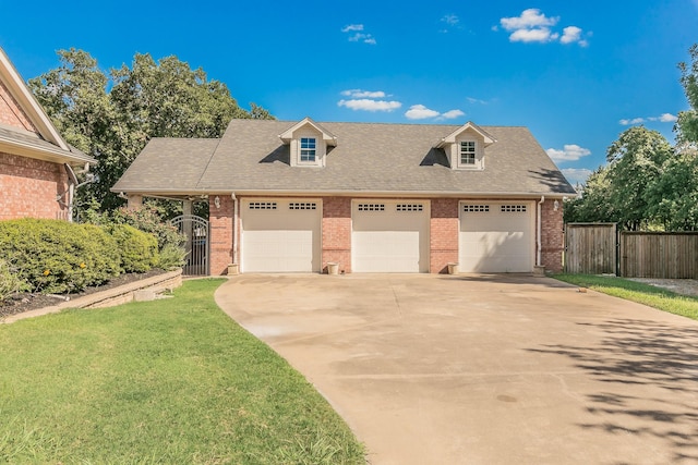 view of front facade featuring a garage, a front yard, and an outdoor structure