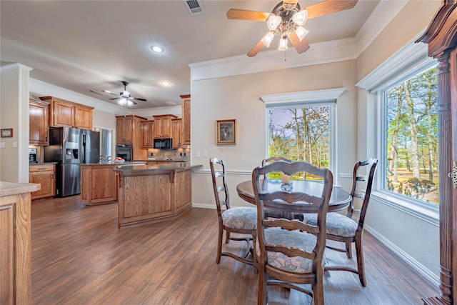 dining space featuring ceiling fan, dark hardwood / wood-style flooring, and ornamental molding