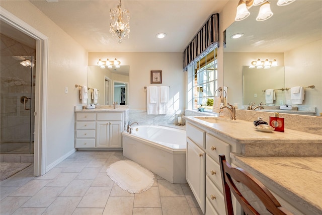 bathroom with vanity, an inviting chandelier, independent shower and bath, and tile patterned flooring