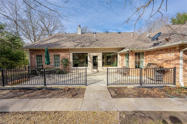 rear view of property featuring a patio area