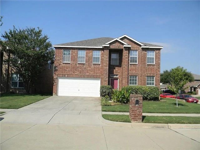 view of front of property with a front yard and a garage