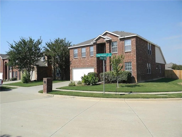 view of front of property with a front yard and a garage