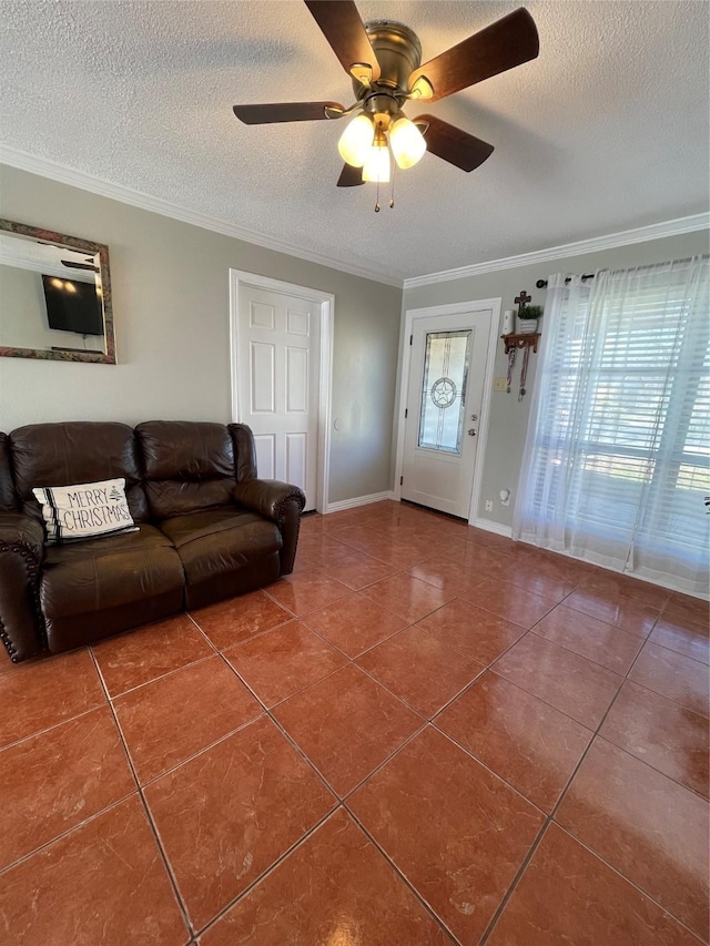 living room featuring a textured ceiling, ceiling fan, tile patterned flooring, and ornamental molding