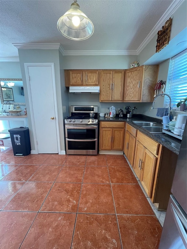 kitchen with sink, range with two ovens, tile patterned floors, and a textured ceiling