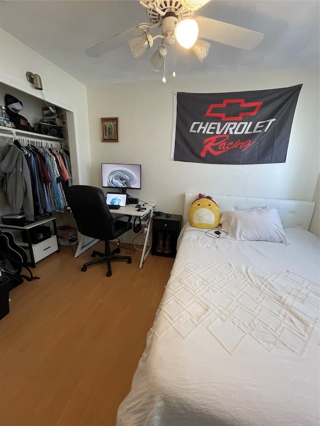 bedroom featuring ceiling fan, a closet, and wood-type flooring