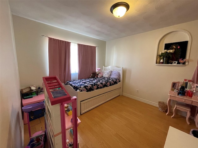 bedroom with hardwood / wood-style floors