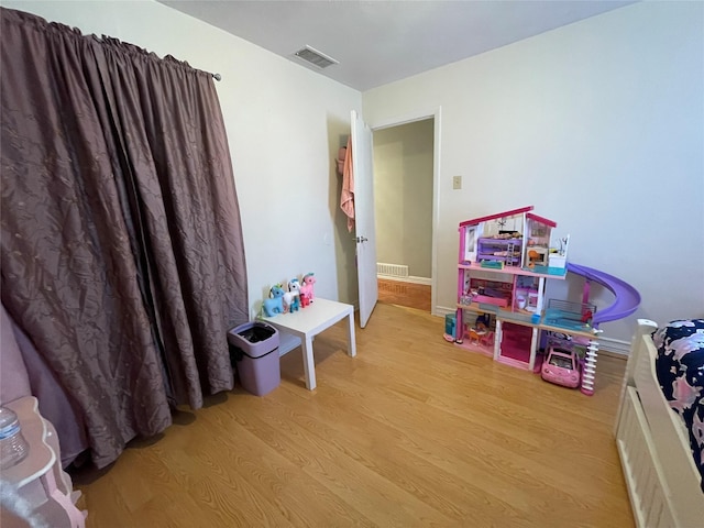 rec room with light hardwood / wood-style flooring