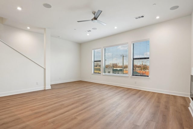 unfurnished room featuring ceiling fan and light wood-type flooring