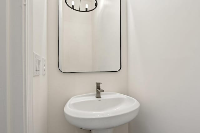 bathroom with a notable chandelier and sink