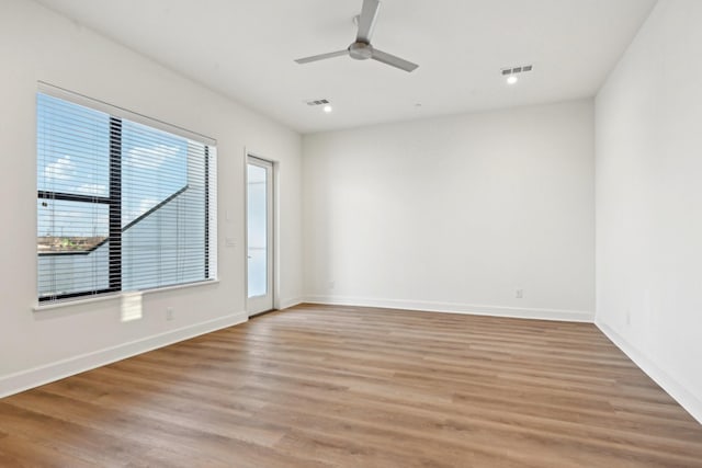 spare room with ceiling fan and light hardwood / wood-style floors