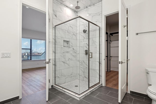 bathroom with toilet, walk in shower, and tile patterned flooring