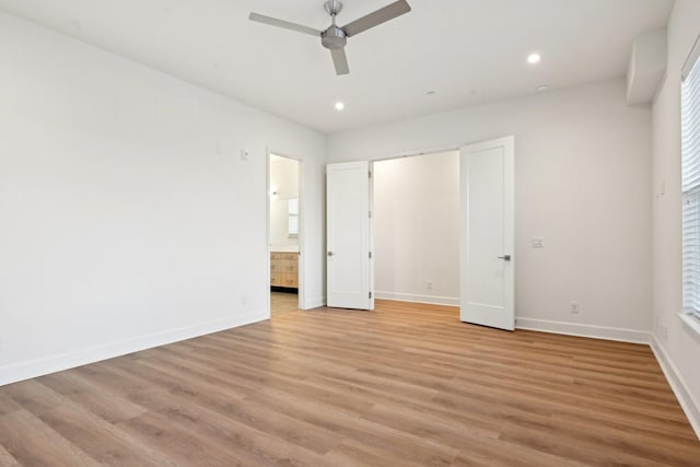 unfurnished bedroom featuring ceiling fan, light hardwood / wood-style flooring, and ensuite bath