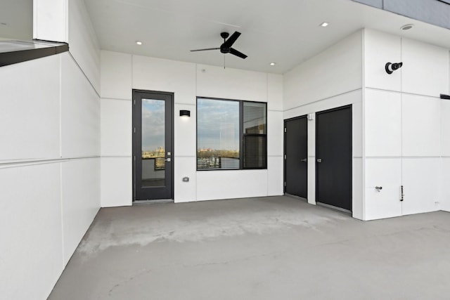 doorway to property with ceiling fan and a patio