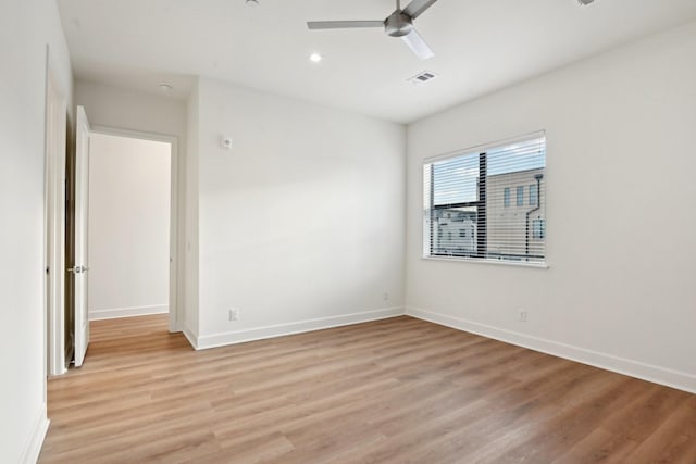 empty room featuring ceiling fan and light wood-type flooring