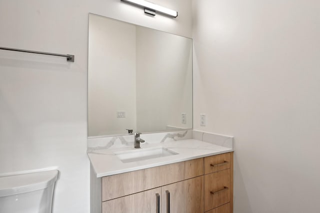 bathroom with toilet and vanity