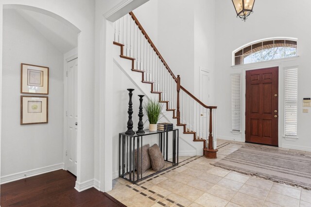 kitchen featuring tasteful backsplash, crown molding, white cabinetry, appliances with stainless steel finishes, and a chandelier