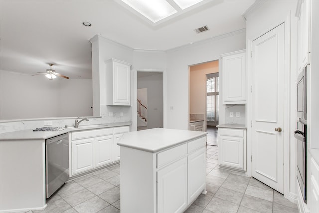 kitchen featuring light tile patterned flooring, stainless steel appliances, white cabinets, and a center island