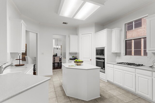 kitchen featuring white cabinetry, oven, and a kitchen island