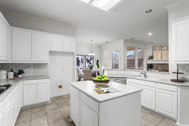 kitchen with kitchen peninsula, stainless steel oven, a notable chandelier, built in microwave, and white cabinets