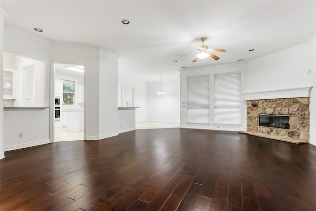 unfurnished living room with ceiling fan, a fireplace, dark hardwood / wood-style flooring, and ornamental molding