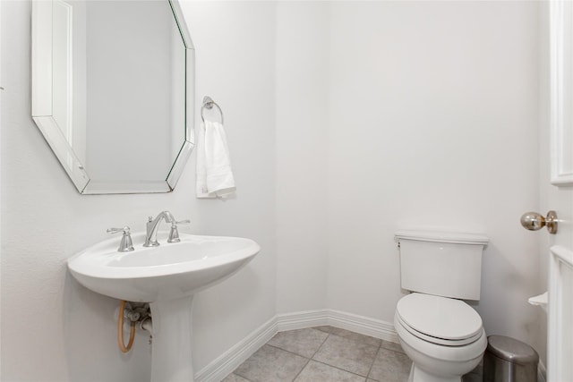 bathroom featuring sink, toilet, and tile patterned flooring