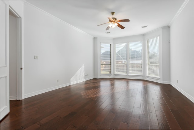 spare room featuring ceiling fan, dark wood-type flooring, and crown molding