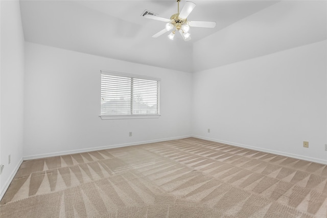 carpeted empty room featuring ceiling fan and lofted ceiling