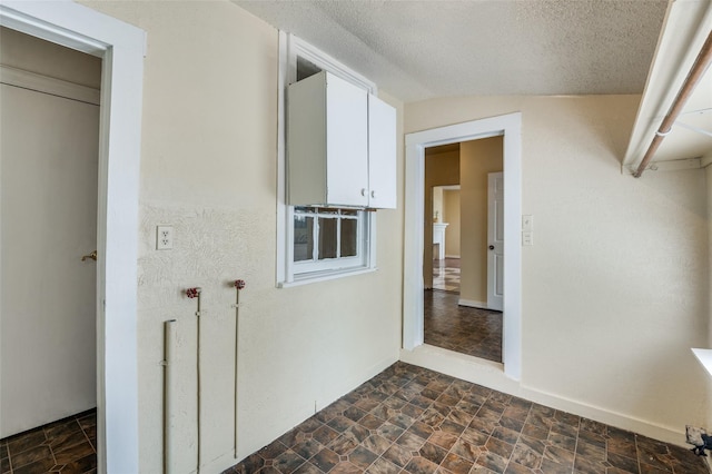 interior space featuring lofted ceiling and a textured ceiling