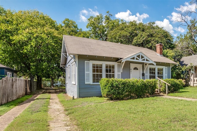 bungalow-style home featuring a front yard