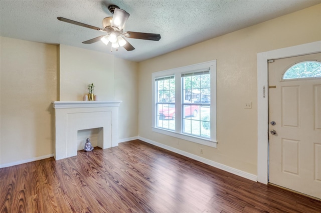 foyer with a textured ceiling, ceiling fan, and hardwood / wood-style flooring