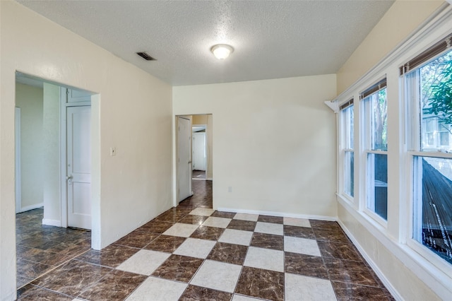 empty room with a textured ceiling