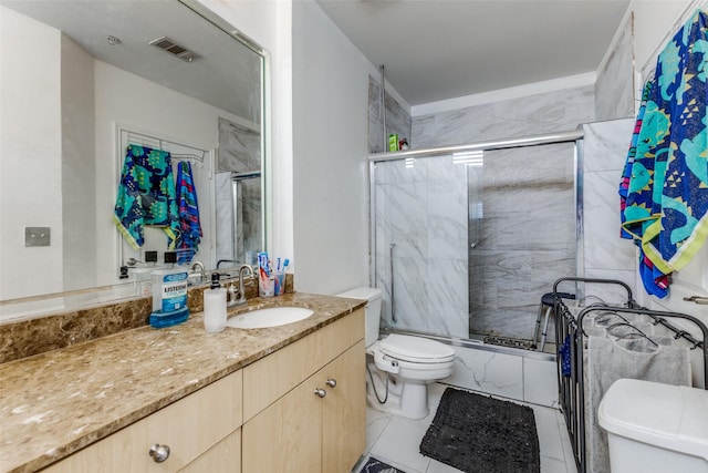 full bathroom featuring enclosed tub / shower combo, vanity, toilet, and tile patterned flooring