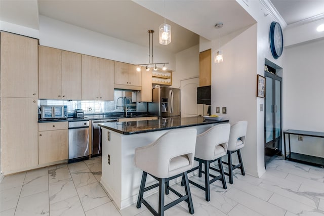 kitchen featuring light brown cabinets, stainless steel appliances, hanging light fixtures, kitchen peninsula, and a breakfast bar