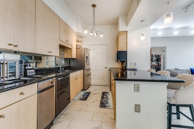 kitchen with a kitchen breakfast bar, pendant lighting, sink, and stainless steel appliances