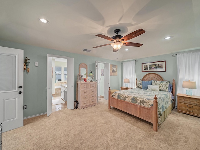 carpeted bedroom with ceiling fan and connected bathroom