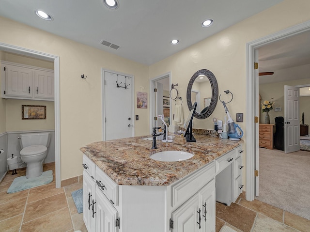 bathroom with toilet and vanity