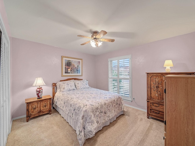 carpeted bedroom featuring ceiling fan and a closet